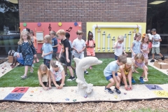 Kindergarteners place rocks in the garden on opening day June 5.