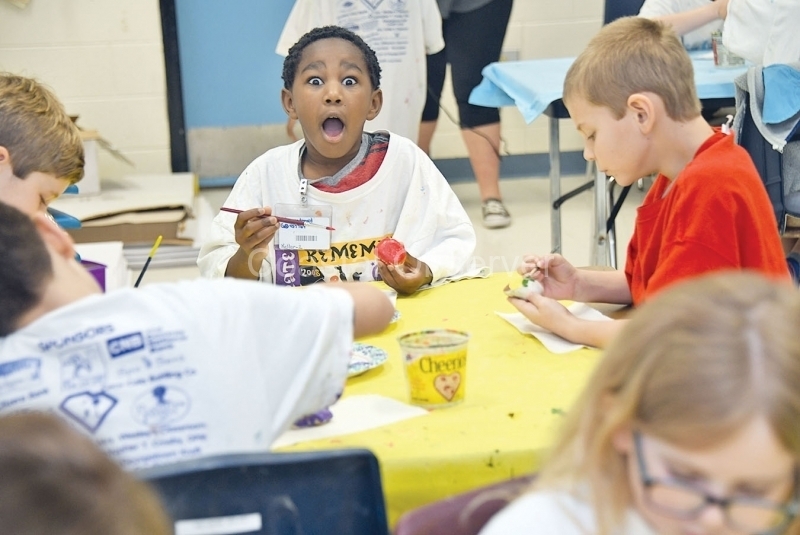 Earlier this year, students painted rocks. Andrew Wilson, 8, is excited about his design.