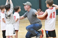 Coach Gus Axelson helps players understand how to play.