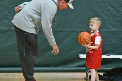 Coach D.J. Colvin explains the game to Chase Presley, 4.