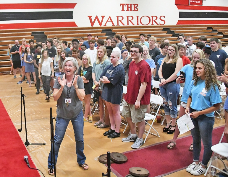 The class held a practice session on Tuesday. Sylvia Plyer, the choral teacher, claps to indicate audience applause.