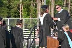 Principal Adam George hands out diplomas.